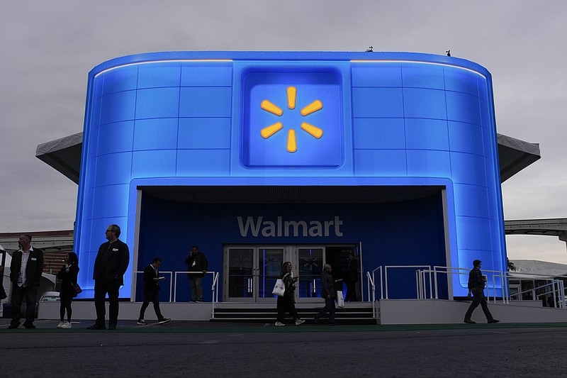 People walk by the Walmart booth during the CES tech show Tuesday, Jan. 9, 2024, in Las Vegas. (AP Photo/John Locher)