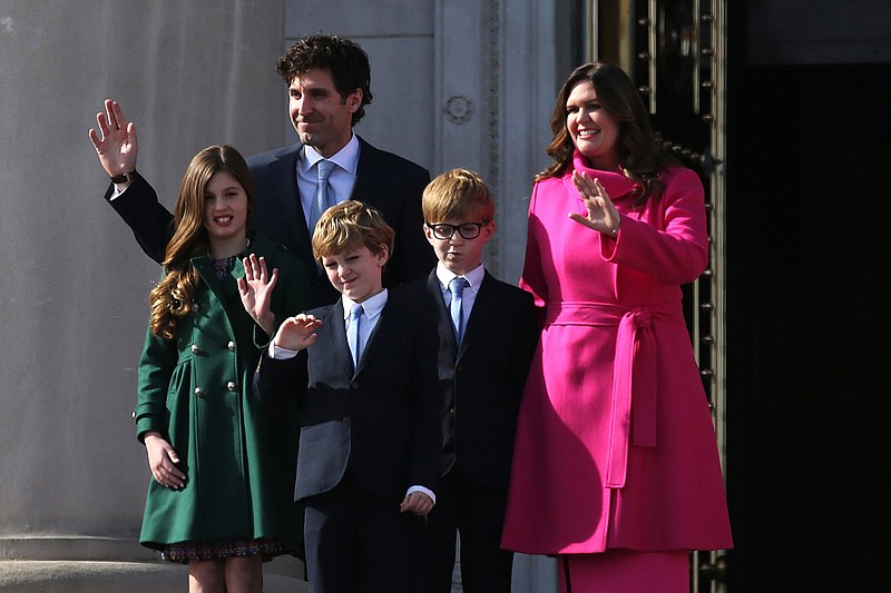 Arkansas Gov. Sarah Huckabee Sanders (right) walks out the doors of the state Capitol in Little Rock with her husband Brian and their kids, (from left) Scarlett, George and Huck, during Sanders' inauguration ceremony in this Jan. 10, 2023 file photo. (Arkansas Democrat-Gazette/Thomas Metthe)