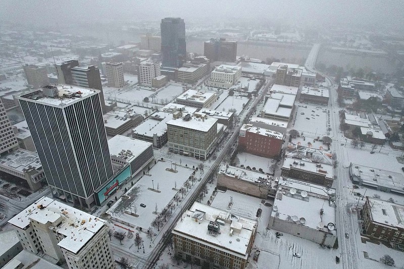 Snow falls over downtown Little Rock on Sunday, Jan. 14, 2024 as a winter storm sweeps across the state. (Arkansas Democrat-Gazette/Colin Murphey)