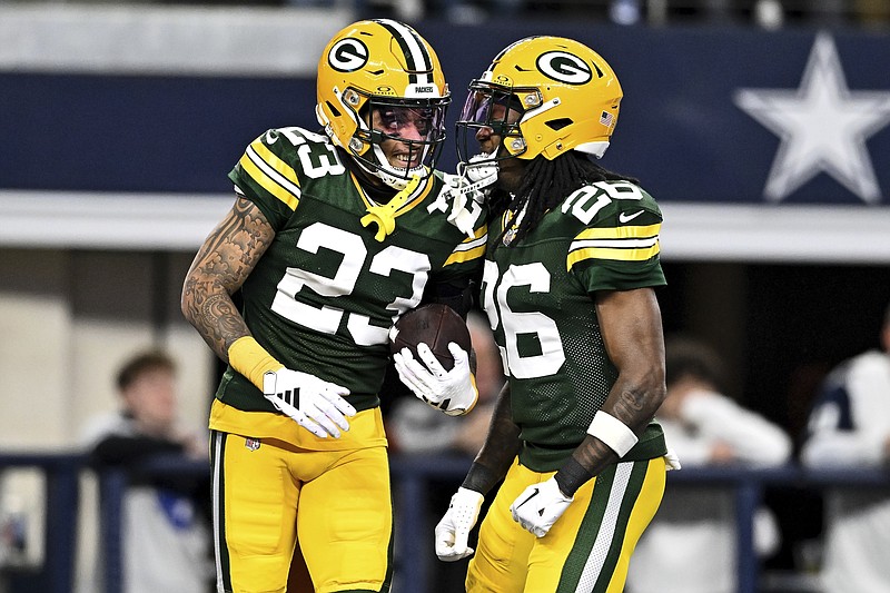 Green Bay Packers cornerback Jaire Alexander (23) reacts after intercepting a pass with safety Darnell Savage (26) during the first half of an NFL football game Sunday, Jan. 14, 2024 in Arlington, Texas. (AP Photo/Maria Lysaker)