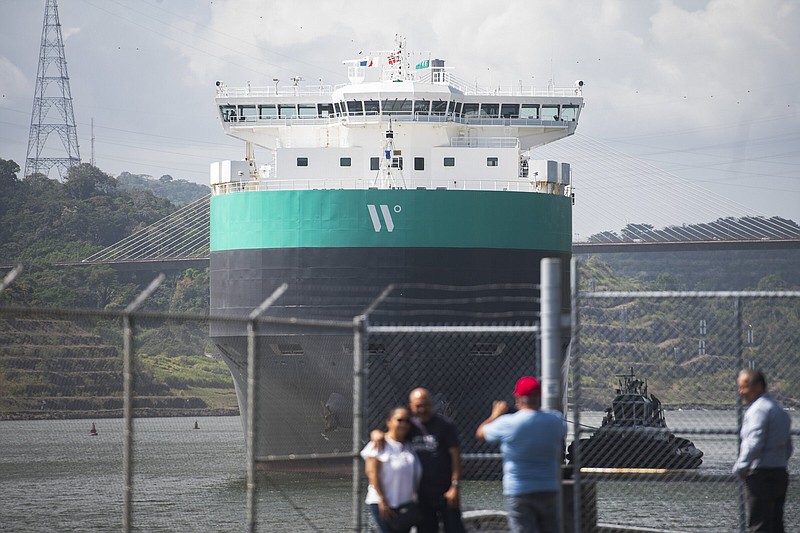 A cargo ship is guided through the Panama Canal in Panama City on Wednesday.
(AP/Agustin Herrera)