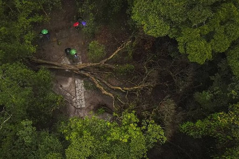 Villagers stand near a large, fallen tree in Mawphlang sacred forest, one of the most renowned in Meghalaya, a state in northeastern India. The sacred stones in Mawphlang have served as recipients of chants, songs and prayers for centuries.
(AP/Anupam Nath)