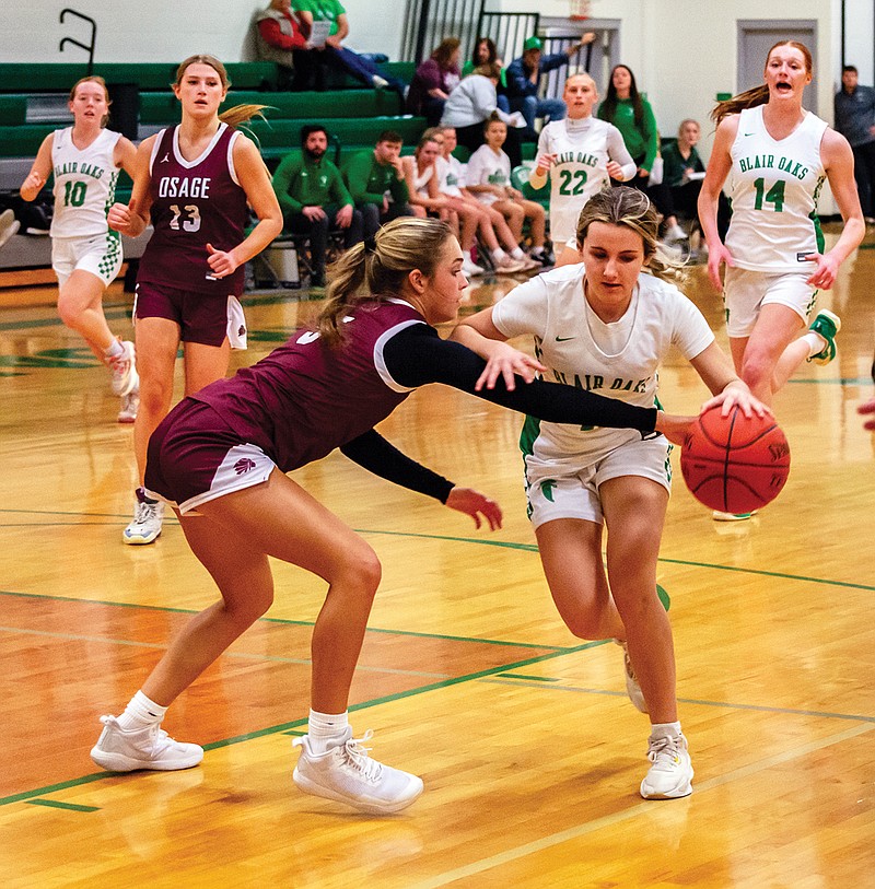 Hattie Meldrum of Blair Oaks tries to protect the ball against the defense of School of the Osage’s Andie Job during Tuesday night’s game at Blair Oaks Middle School in Wardsville. (Ken Barnes/News Tribune)