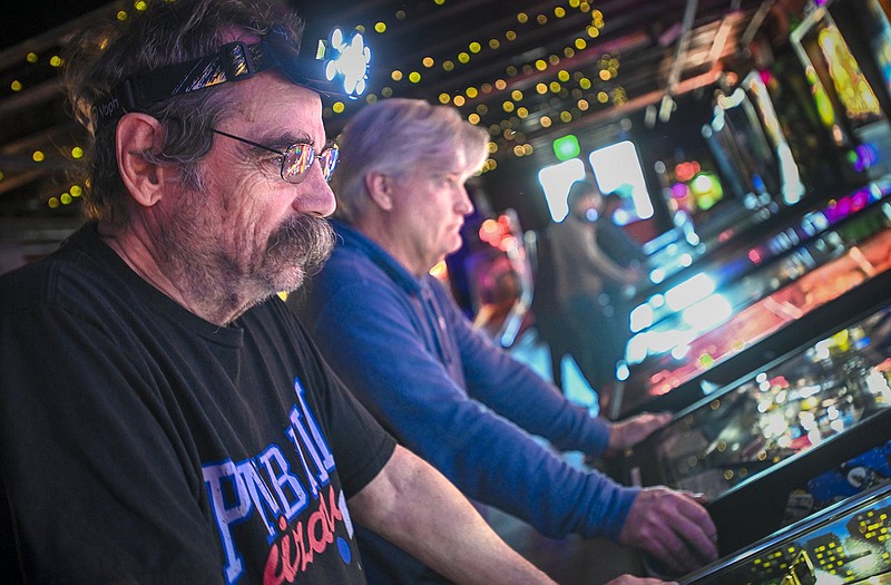 Mark Gunter of Hope plays pinball, Saturday, January 28, 2024 during a pinball tournament at Pinpoint in Fayetteville. Visit nwaonline.com/photos for today's photo gallery...(NWA Democrat-Gazette/Charlie Kaijo)