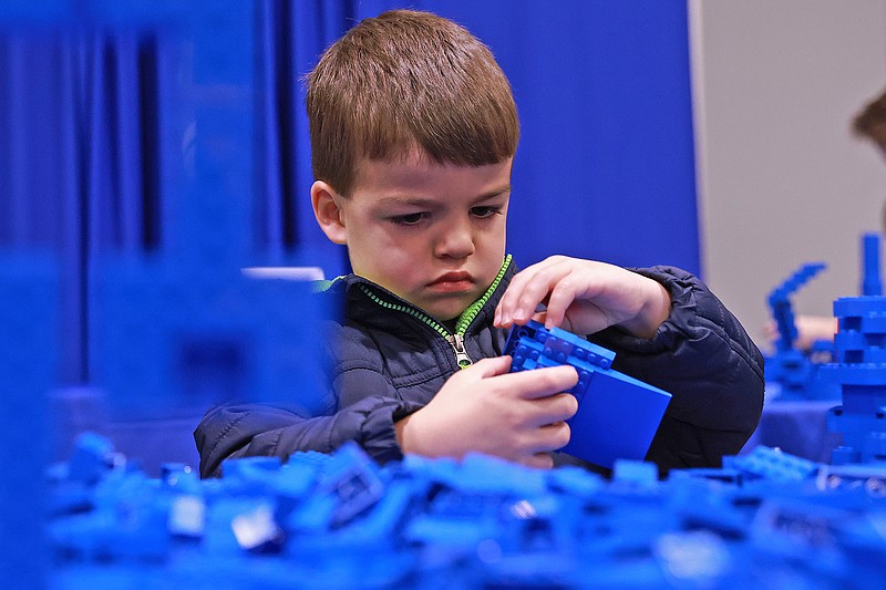 Mateo Merlos, 4, plays with blue Lego blocks during the BrickUniverse Lego Convention at the Statehouse Convention Center on Sunday, Feb. 4, 2024. See more photos at arkansasonline.com/25lego/ (Arkansas Democrat-Gazette/Colin Murphey)