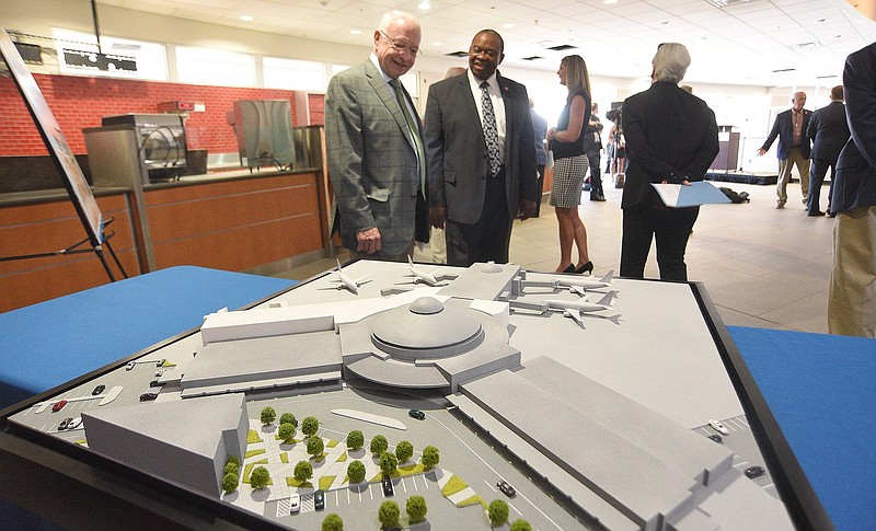 Staff photo by Matt Hamilton / Jim Hall, left, Chattanooga Airport Authority chair, and State Rep. Yusuf Hakeem, D-Chattanooga, talk as they look at a model for the airport passenger terminal expansion in June 2022.