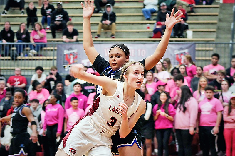 Jefferson City's Lyssa Sportsman moves around the defense of Capital City's Emily Thames during Tuesday night's game at Fleming Fieldhouse. (Alexa Pfeiffer/News Tribune)