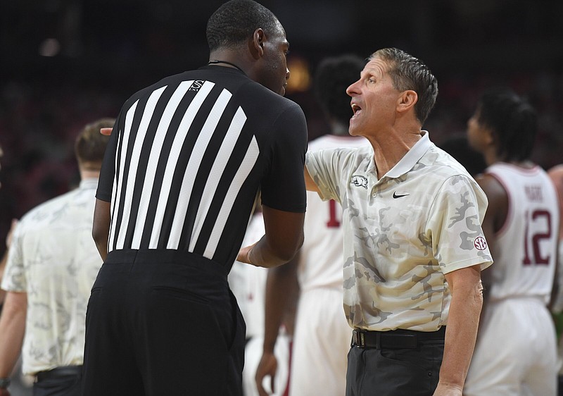 Coach Eric Musselman (right) argues with an official during the Arkansas men’s basketball team’s 78-72 loss to North Carolina-Greensboro on Nov. 17 at Walton Arena in Fayetteville. The Razorbacks opened the season at No. 14 in The Associated Press top 25 poll, but have fallen out of the poll and are currently 11-11 overall and 2-7 in the SEC.
(NWA Democrat-Gazette/Andy Shupe)