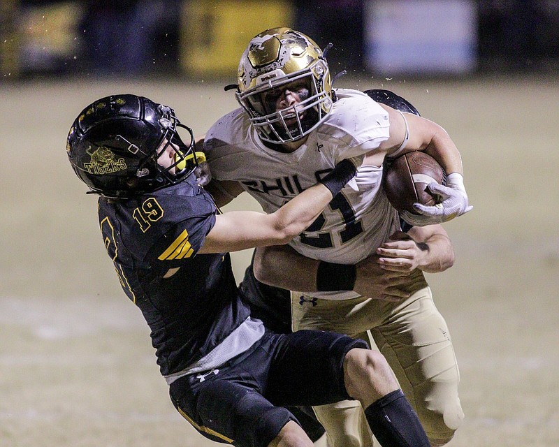 Shiloh Christian running back Bo Williams (right) signed a national letter of intent with NCAA Division II national champion Harding University on Wednesday. Williams rushed for 1,935 yards and 38 touchdowns to help lead the Saints back to the Class 5A state championship game.
(Special to the NWA Democrat-Gazette/Brent Soule)