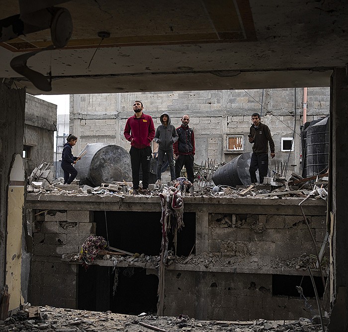 Palestinians examine the destruction Friday after an Israeli airstrike in Rafah, Gaza Strip. More photos at arkansasonline.com/gazaweek18/.
(AP/Fatima Shbair)