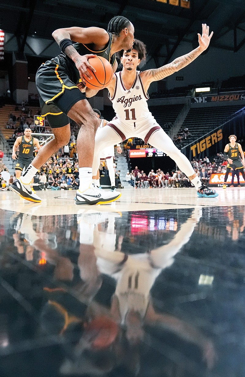 Missouri’s Tamar Bates looks to pass around Texas A&M’s Andersson Garcia during Wednesday night’s game at Mizzou Arena in Columbia. (Associated Press)