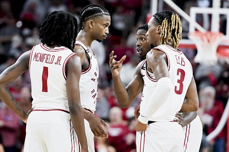 Arkansas guards Keyon Menifield (from left), Tramon Mark, Davonte Davis and El Ellis huddle Saturday during the Razorbacks 78-75 victory over the Georgia Bulldogs at Walton Arena in Fayetteville. Coach Eric Musselman used a four-guard lineup for much of the game.
(NWA Democrat-Gazette/Charlie Kaijo)