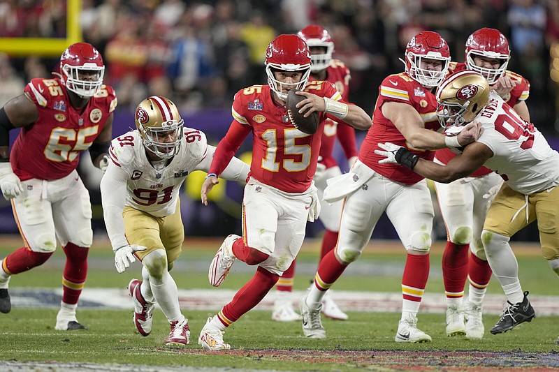 Kansas City Chiefs quarterback Patrick Mahomes (15) rushes during overtime of Super Bowl LVIII Sunday in Las Vegas. Mahomes scrambled for a pair of first downs in overtime before throwing the game-winning touchdown to Mecole Hardman.
(AP/Doug Benc)