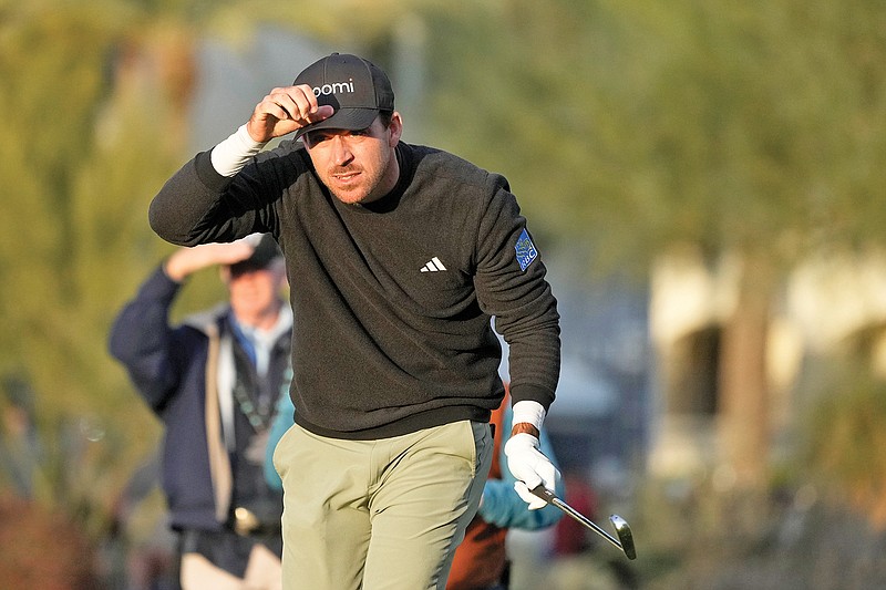 Nick Taylor watches his approach shot on the fifth hole during Saturday’s third round of the Phoenix Open in Scottsdale, Ariz. (Associated Press)