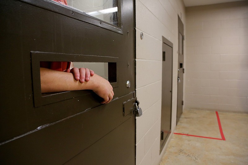An Arkansas juvenile rests his hands on the food opening in his cell door in this July 28, 2015 file photo. (Arkansas Democrat-Gazette/Stephen B. Thornton)