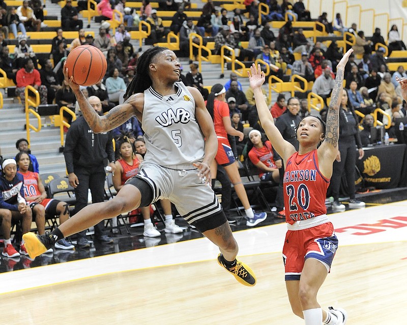 UAPB guard Jelissa Reese (5) attempts a midair pass while guarded by Jackson State guard Areyanna Hunter (20) during Monday night's women's basketball game at H.O. Clemmons Arena in Pine Bluff. (Special to the Commercial/William Harvey)