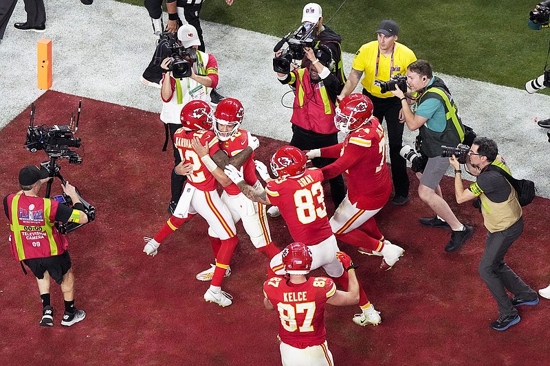 Chiefs quarterback Patrick Mahomes (center) celebrates with wide receiver Mecole Hardman and other teammates after throwing the game-wining touchdown during overtime of Super Bowl 58 against the 49ers in Las Vegas. (Associated Press)