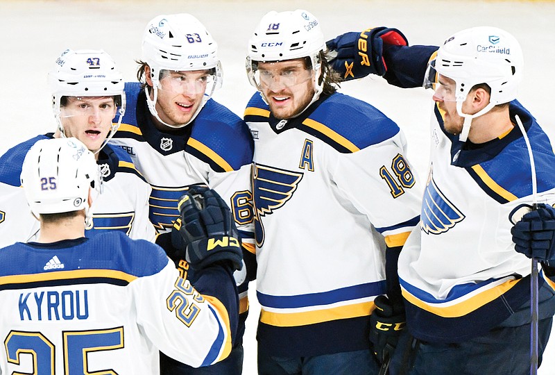 Blues players celebrate after scoring a third-period goal Sunday afternoon in a win against the Canadiens in Montreal. (Associated Press)
