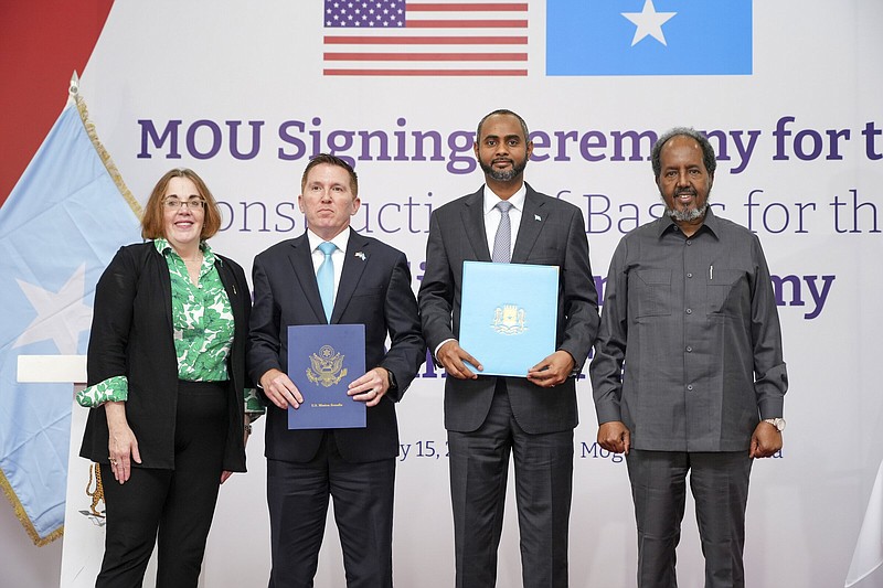 Hassan Sheikh Mohamud, Somalia’s president (from right), Somalia’s Minister of Defense Abdulkadir Mohamed Nur, Chargé d’Affaires to the U.S. Embassy Shane L. Dixon and Assistant Secretary of State for African Affairs Mary Catherine Phee pose Thursday during the signing of a memorandum of understanding in Mogadishu, Somalia.
(AP/Farah Abdi Warsameh)