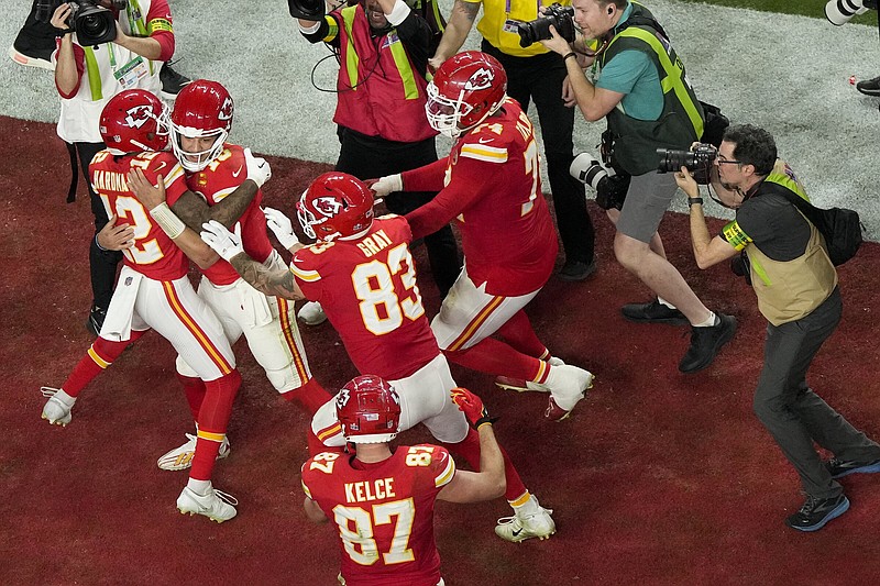Kansas City Chiefs quarterback Patrick Mahomes, center, celebrates with wide receiver Mecole Hardman Jr. (12) after throwing the game-wining touchdown during overtime of the NFL Super Bowl 58 football game against the San Francisco 49ers Sunday, Feb. 11, 2024, in Las Vegas. (AP Photo/David J. Phillip)