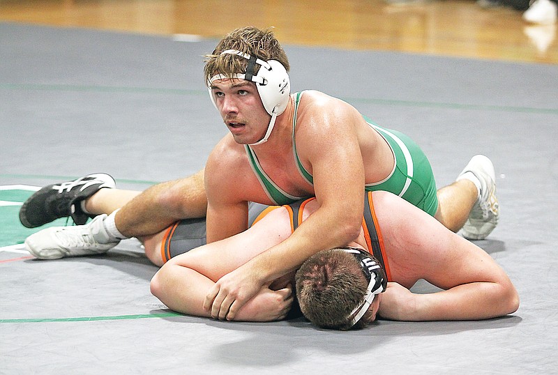 Cole Peters of Blair Oaks looks to the Falcon bench for instruction as he wrestles against Kirksville’s Cody Drury during their 285-pound match in the Blair Oaks Duals earlier this month at Blair Oaks High School in Wardsville. (Greg Jackson/News Tribune)