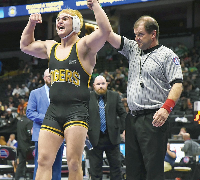 Tristin Gavette of Versailles celebrates after winning a title at 285 pounds Thursday night during the Class 1 boys wrestling state championships at Mizzou Arena in Columbia. (Cleo Norman/News Tribune)
