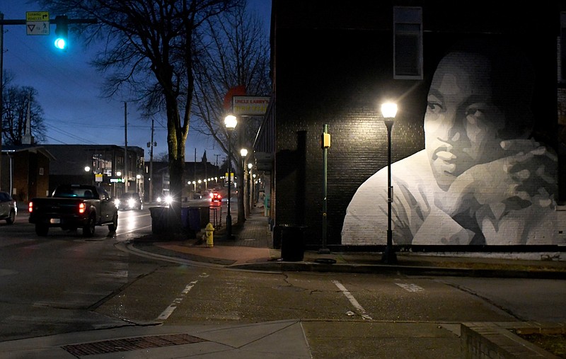 Staff Photo by Robin Rudd / Dawn breaks in the eastern sky as a mural of Martin Luther King Jr. appears to look upon traffic on the street that bears his name. The artwork, which is located at the intersection of Marin Luther King Jr. Blvd, and Peeples Street, was painted by Chattanooga muralist Kevin Bate in 2012.