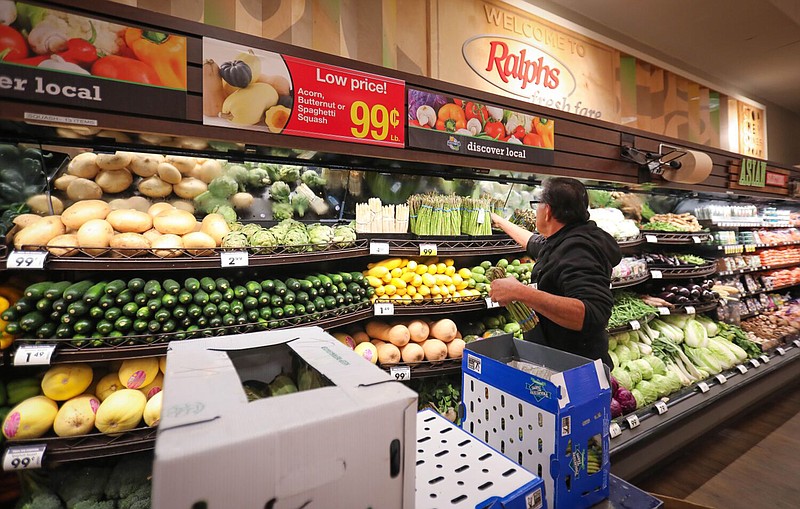 Victor Marcus, a produce clerk at the Ralphs supermarket in the La Jolla Square shopping center, restocks produce at the store March 19, 2020 in San Diego. (Howard Lipin/The San Diego Union-Tribune/TNS)