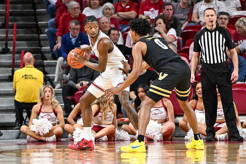 Arkansas guard Tramon Mark (12) is defended by Vanderbilt guard Tyrin Lawrence (0) during a game Tuesday, Feb. 27, 2024, in Fayetteville. (Caleb Grieger/NWA Democrat-Gazette)