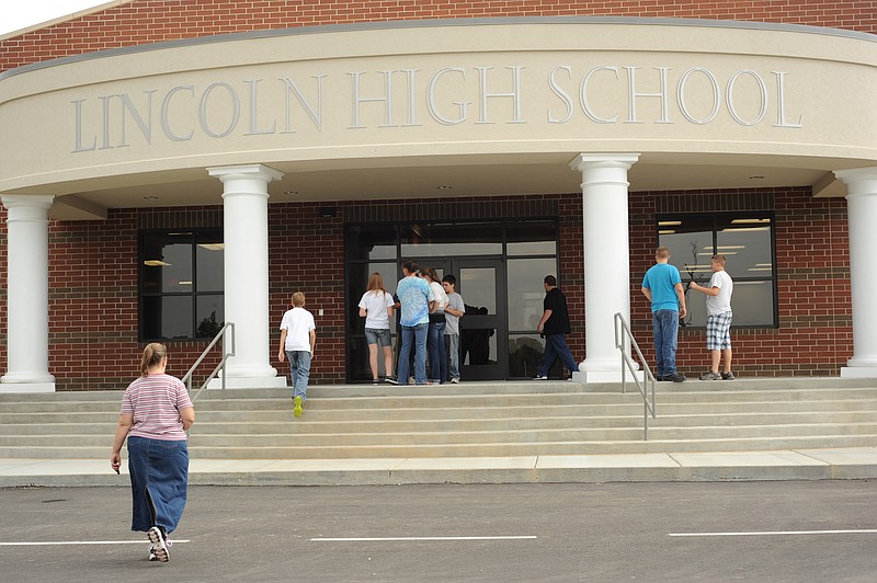 STAFF PHOTO ANDY SHUPE.Parents and students walk Thursday, Aug. 16, 2012, to the entrance of Lincoln High School during a tour of the newly constructed high school building ahead of the first day of school, which is set for Monday.