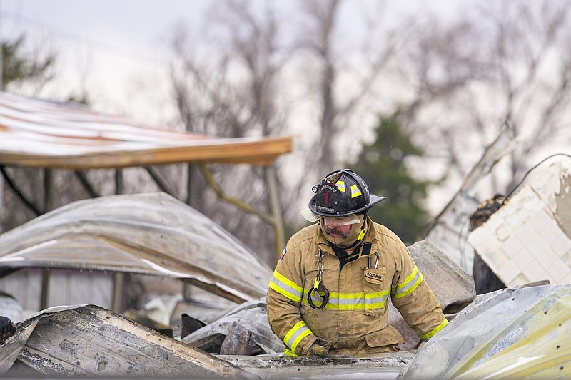 A fire official from Lubbock, Texas, helps put out the smoldering debris of a home destroyed by the Smokehouse Creek fire in Stinnett, Texas, on Thursday.
(AP/Julio Cortez)