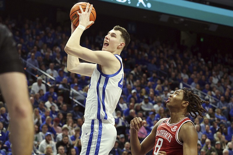 Kentucky's Zvonimir Ivisic, left, looks to shoot in front of Arkansas' Chandler Lawson (8) during the second half of an NCAA college basketball game Saturday, March 2, 2024, in Lexington, Ky. (AP Photo/James Crisp)