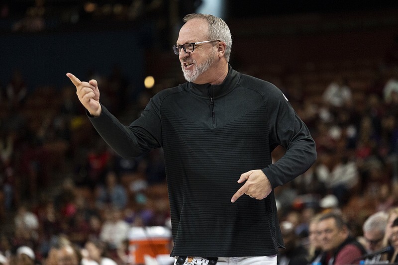 Arkansas head coach Mike Neighbors gestures to his players in the first half of an NCAA college basketball game against South Carolina during the Southeastern Conference women's tournament in Greenville, S.C., Friday, March 3, 2023. (AP Photo/Mic Smith)