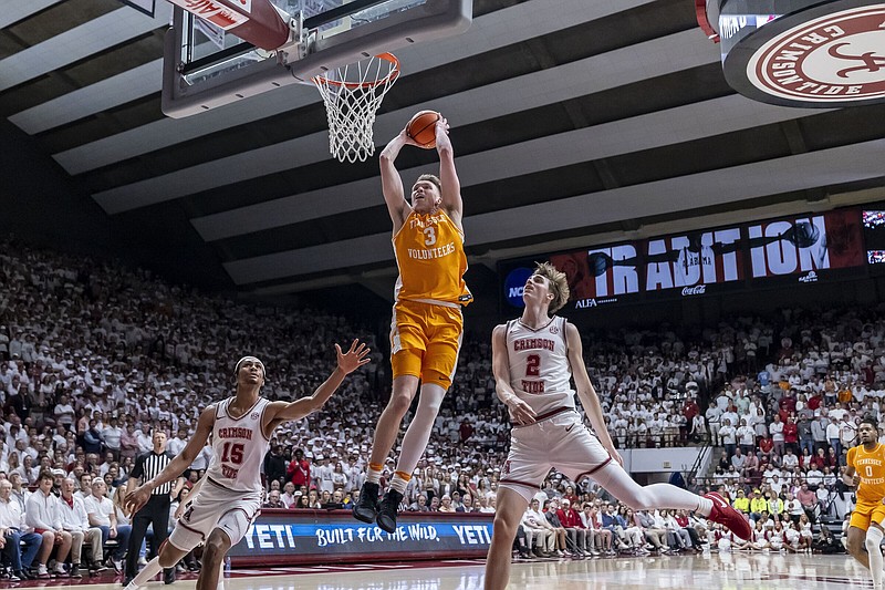 Tennessee guard Dalton Knecht (3) dunks past Alabama forwards Jarin Stevenson (15) and Grant Nelson (2) during the first half of an NCAA college basketball game, Saturday, March 2, 2024, in Tuscaloosa, Ala. (AP Photo/Vasha Hunt)