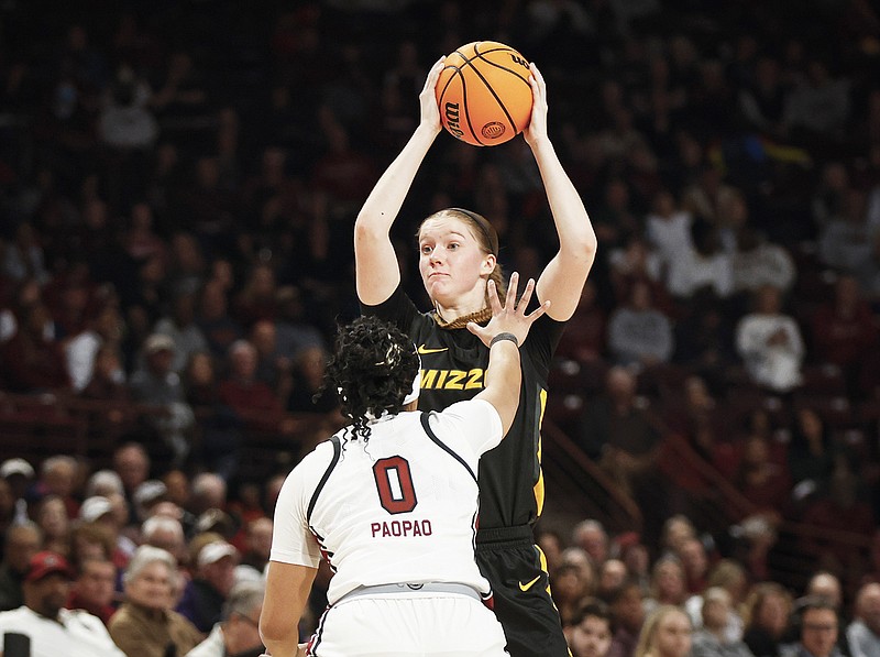 Missouri guard Grace Slaughter looks to pass over South Carolina guard Te-Hina Paopao during last month's game in Columbia, S.C. (Associated Press)