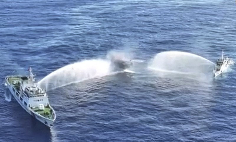 Philippine resupply vessel Unaizah, center, is hit by two Chinese coast guard water cannon blasts, causing injuries to multiple crew members as they tried to enter the Second Thomas Shoal, locally known as Ayungin Shoal, in the disputed South China Sea, on Tuesday.
(AP/Philippine Coast Guard)