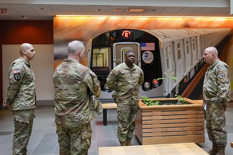 Members of the Armed Forces including the National Guard wait in the lobby of the New York City Mass Transit Authority Rail Control Center before the start of a news conference with Gov. Hochul on Wednesday in New York.
(AP/Mary Altaffer)