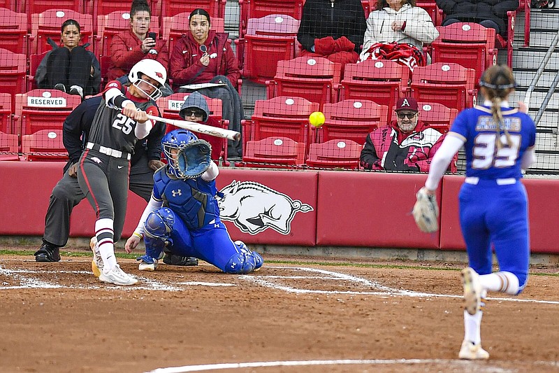 Hannah Camenzind (25), shown hitting a single against South Dakota State on Feb. 29, has primarily been used as a pitcher this season, but her hitting has forced Coach Courtney Deifel to find a place for her in the Razorbacks’ batting order.
(NWA Democrat-Gazette/Hank Layton)