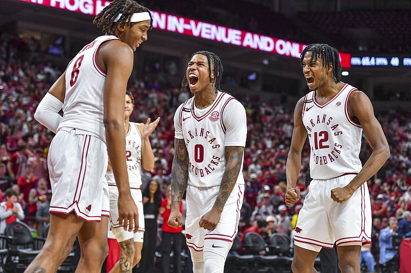 Arkansas forward Chandler Lawson (8) reacts with teammates Trevon Brazile (2), Khalif Battle (0) and Tramon Mark (12) after getting fouled on a made basket, Wednesday, March 6, 2024, during the second half of the Razorbacks’ 94-83 win over the LSU Tigers at Bud Walton Arena in Fayetteville. Visit nwaonline.com/photo for today's photo gallery..(NWA Democrat-Gazette/Hank Layton)