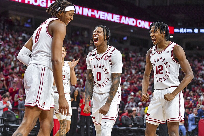 Guard Khalif Battle (middle), shown with teammates Chandler Lawson (left) and Tramon Mark during Wednesday’s game against LSU, and the Arkansas Razorbacks shot a season-high 60.8% from the field to beat the Tigers. It’s something they hope to do again today when they face the No. 16 Alabama Crimson Tide. “The guys that are playing are more confident. Everybody’s playing harder for each other,” Battle said.
(NWA Democrat-Gazette/Hank Layton)