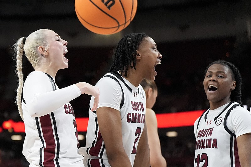 AP photo by Chris Carlson / From left, South Carolina basketball players Chloe Kitts, Ashlyn Watkins and MiLaysia Fulwiley celebrate after the Gamecocks scored against Texas A&M during an SEC tournament quarterfinal Friday in Greenville, S.C. The top-ranked, top-seeded Gamecocks improved to 30-0 and will face fifth-seeded Tennessee on Saturday.