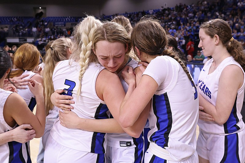Mammoth Springs’ Adrianna Corbett, center, celebrates winning the 1A girls state basketball championship game with teammates Laney Young, left, and Molly Corbett, right, at the OZK Arena in Hot Springs on Saturday, March 9, 2024. See more photos at arkaansasonline.com/310girls1A/ (Arkansas Democrat-Gazette/Colin Murphey).