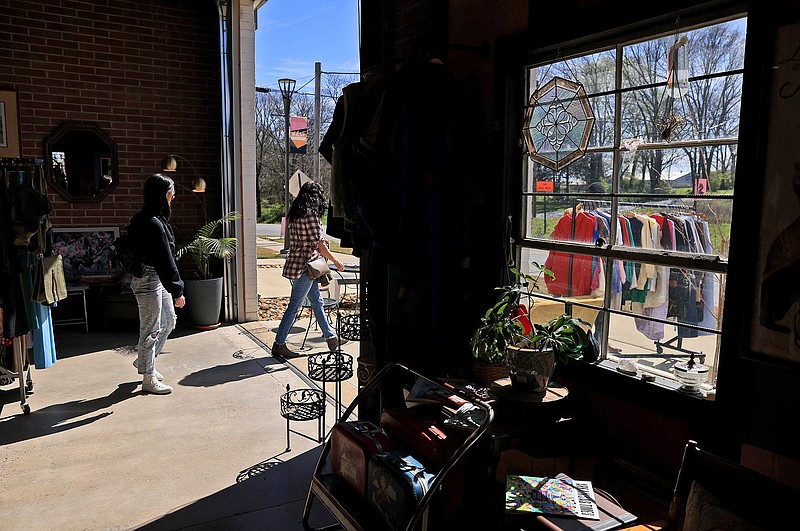 Shoppers peruse racks of merchandise at the Lost and Found Market hosted by the Dog Eat Dog vintage clothing store in Little Rock on Sunday, March 10, 2024. (Arkansas Democrat-Gazette/Colin Murphey)