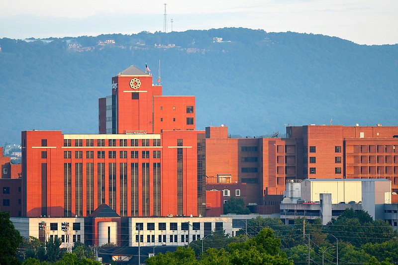 Staff Photo by Robin Rudd / The rising sun illuminates the Erlanger Baroness Campus and Baroness Hospital in 2022, with Elder Mountain serving as a backdrop. The Baroness Hospital is one of six in the Erlanger Health System.