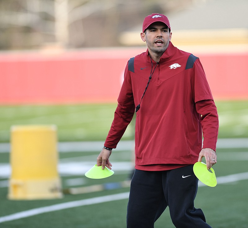 Arkansas assistant coach Ronnie Fouch directs his players Tuesday, March 12, 2024, during practice at the university practice field in Fayetteville. Visit nwaonline.com/photo for today's photo gallery..(NWA Democrat-Gazette/Andy Shupe)