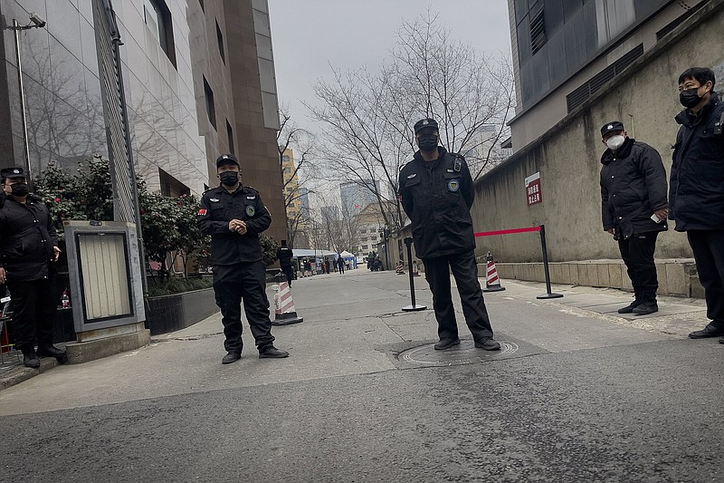 Security personnel stand outside the barricaded Sichuan Trust office building in Chengdu in southwestern China’s Sichuan Province in late February.
(AP/Andy Wong)
