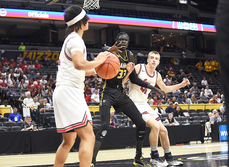Jefferson City's Kendric Johnson looks to inbound the ball as Vianney's Symon Ghai and Jefferson City's Nelson Shinkle battle for position during Wednesday afternoon's Class 5 boys state semifinal game at Mizzou Arena in Columbia. (Cleo Norman/News Tribune)