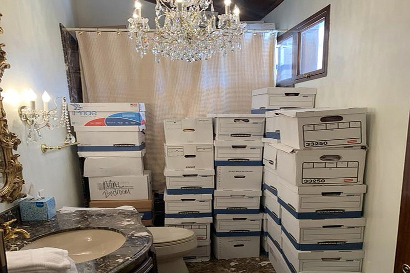 This image, contained in the indictment against former President Donald Trump, shows boxes of records stored in a bathroom and shower in the Lake Room at Trump's Mar-a-Lago estate in Palm Beach, Fla. A federal judge is set to hear arguments on whether to dismiss the classified documents prosecution of Donald Trump. His lawyers say the former president was entitled under the Presidential Records Act to keep the sensitive documents with him when he left the White House and headed to Florida.  (Justice Department via AP)