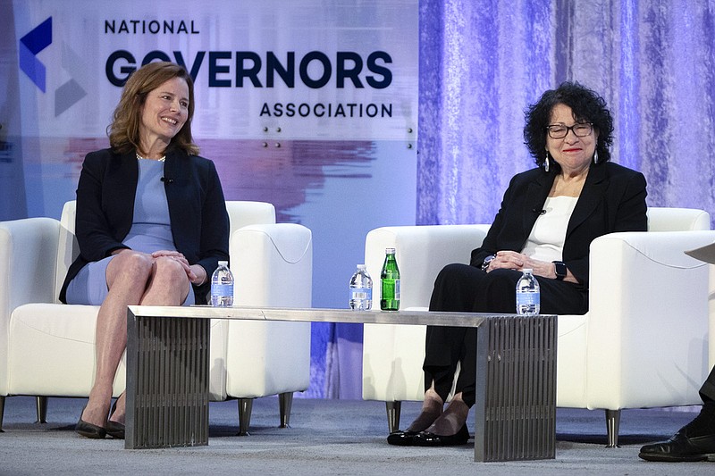 FILE - Supreme Court Justices Amy Coney Barrett, left, and Sonia Sotomayor speak with retired U.S. Appeals Court Judge Thomas Griffith, not shown, during a panel discussion at the winter meeting of the National Governors Association, Feb. 23, 2024 in Washington. In joint appearances less than three weeks apart, ideologically opposite Justices Amy Coney Barrett and Sonia Sotomayor said a Supreme Court where voices don’t get raised in anger can be a model for the rest of the country in these polarized times. (AP Photo/Mark Schiefelbein, File)