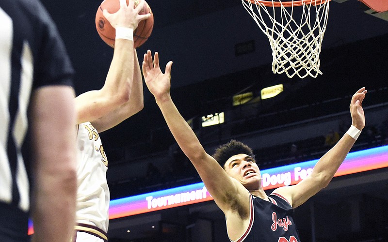 Jefferson City's Jordan Martin reaches in an attempt to block a shot during Thursday night’s Class 5 state championship game against De Smet at Mizzou Arena in Columbia. (Cleo Norman/News Tribune)